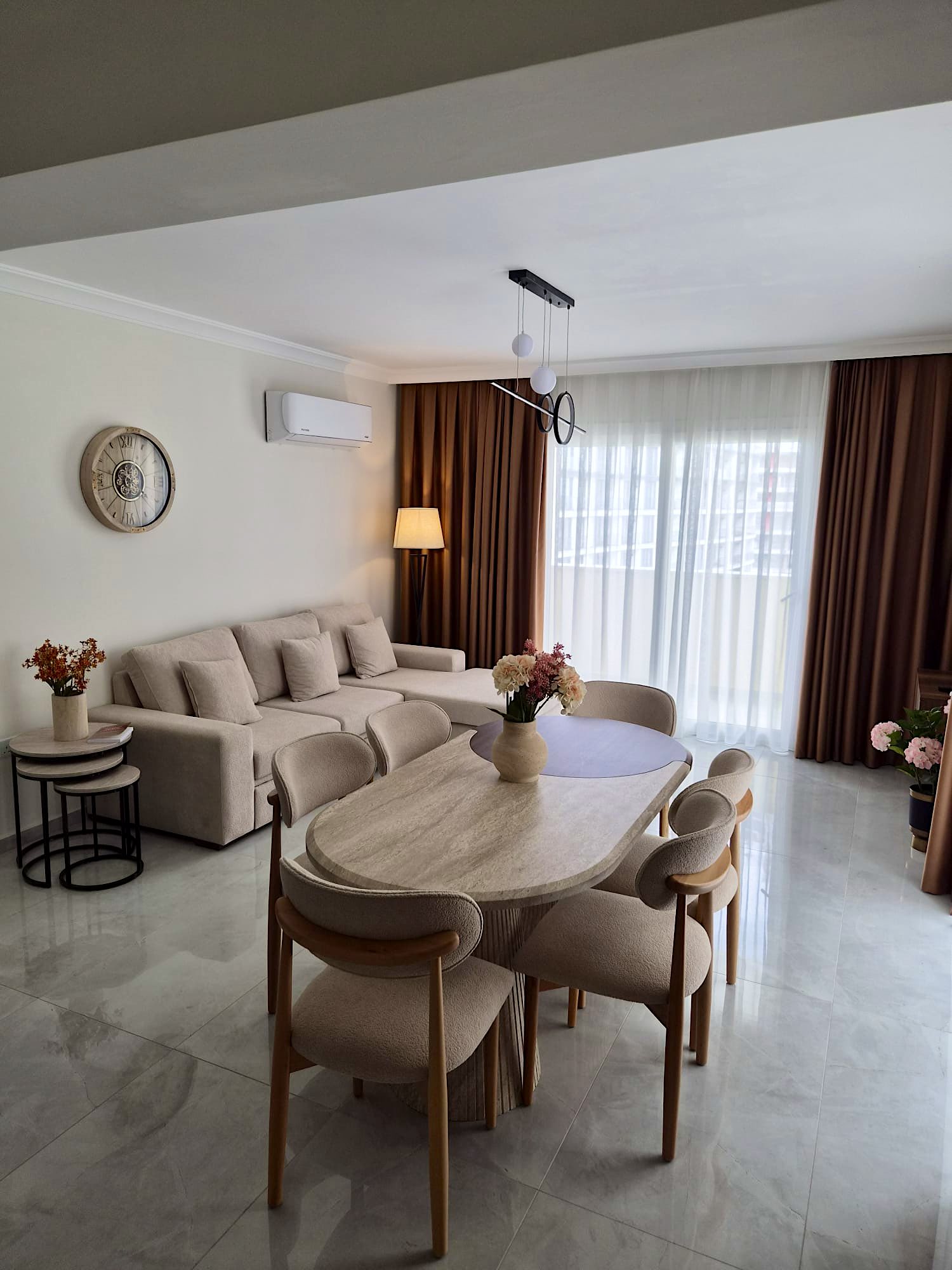Bellagio living room with corner sofa, oval dining table for six and the terrace door