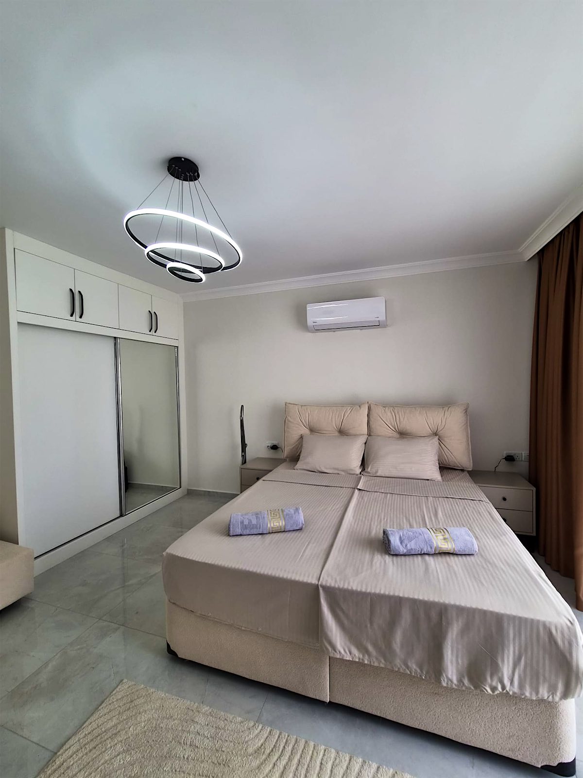 Separate Bellagio bedroom with a large bed and sliding wardrobe