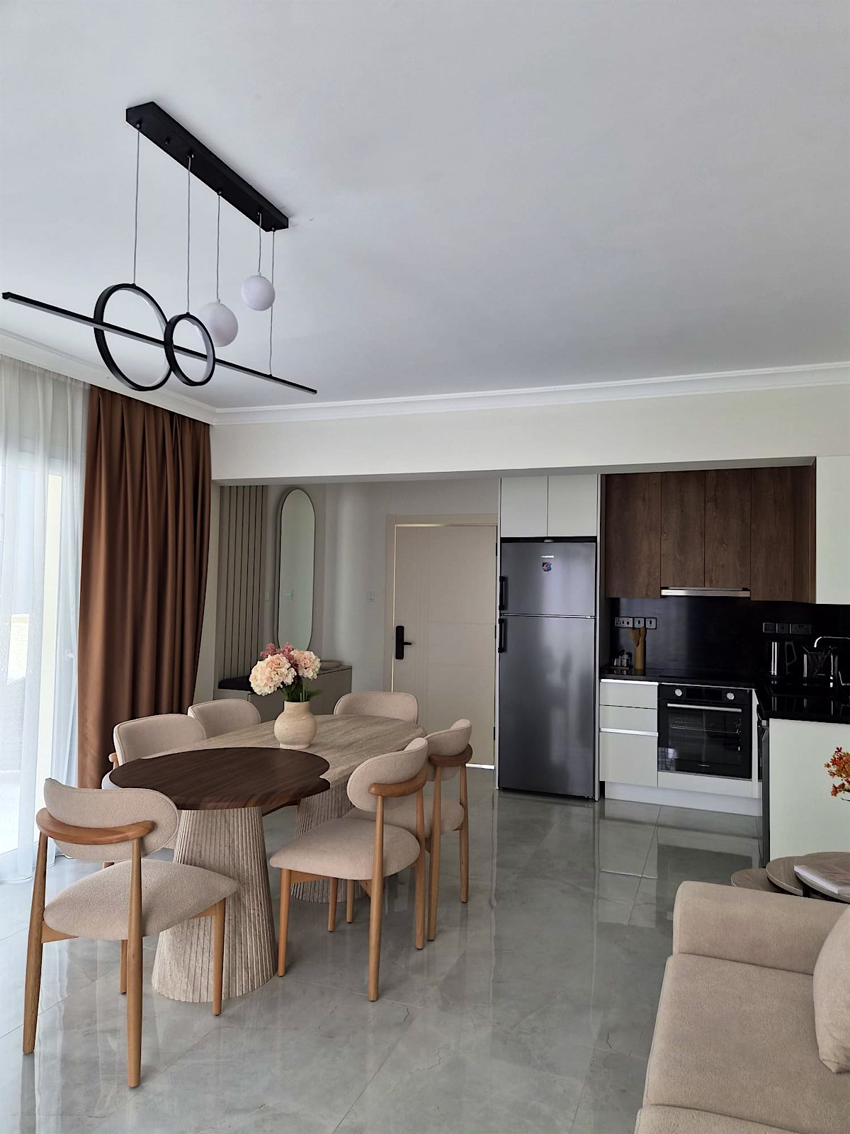 Bellagio dining area and kitchen with oven and tall fridge