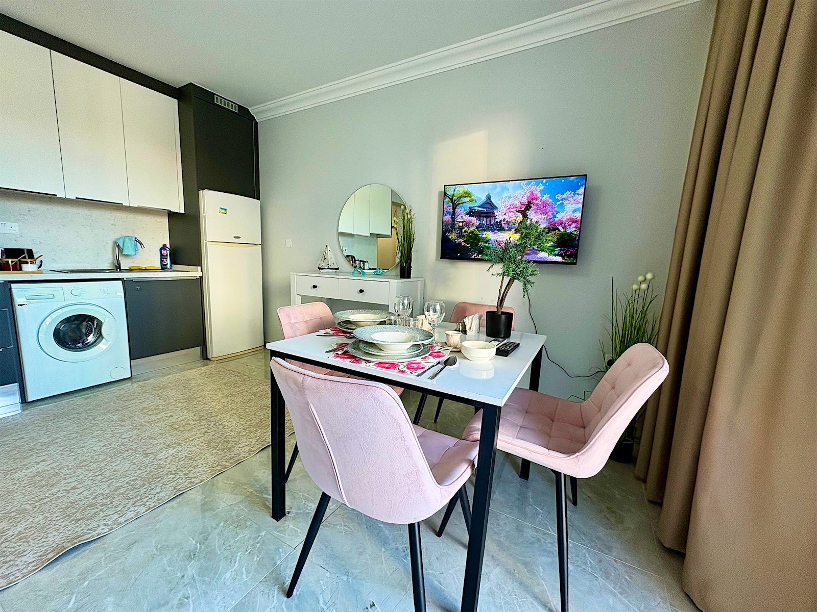 Royal studio kitchen with washing machine, fridge and the dining table