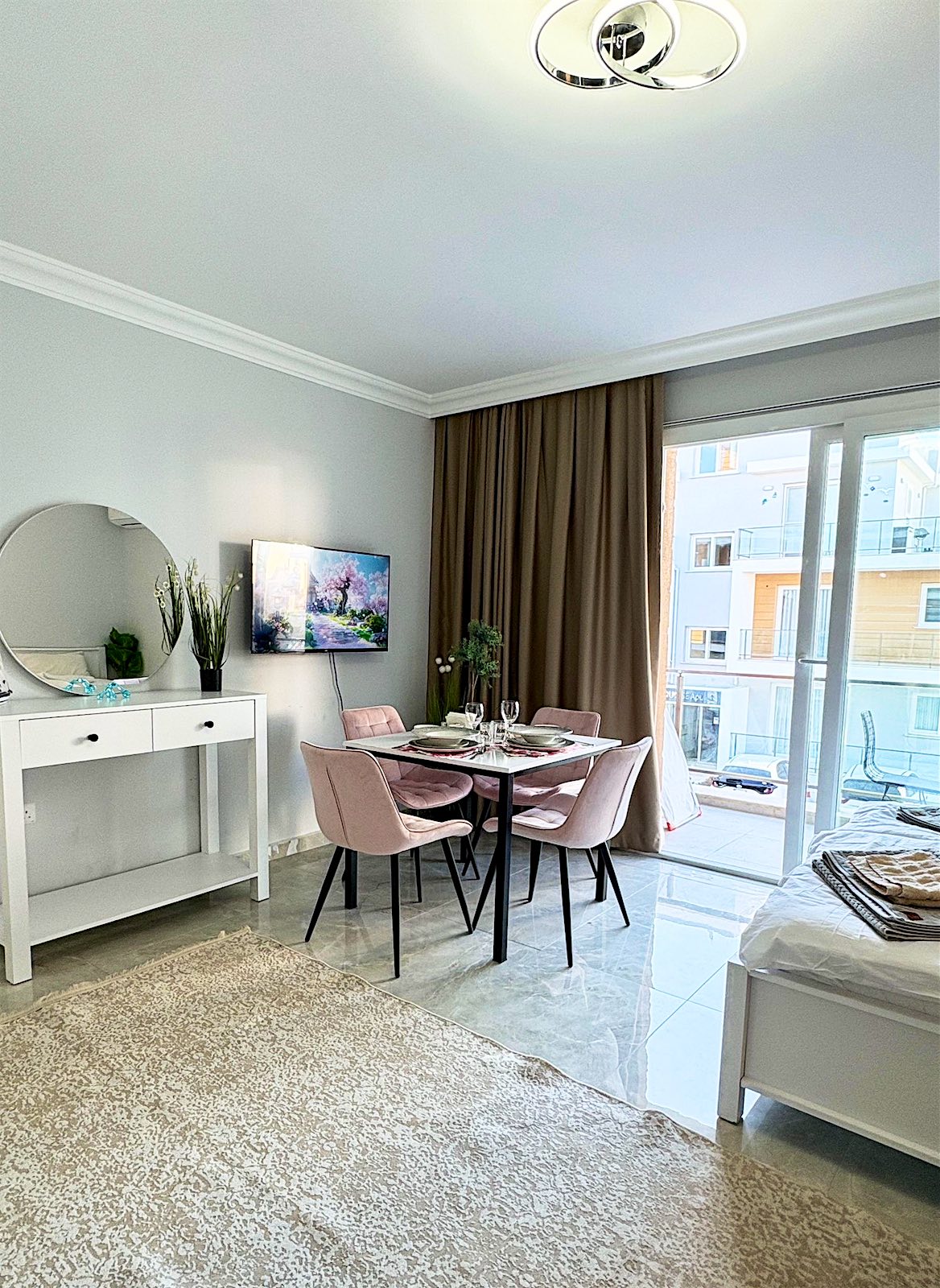 Royal studio: dining table by the balcony door, TV and dressing table