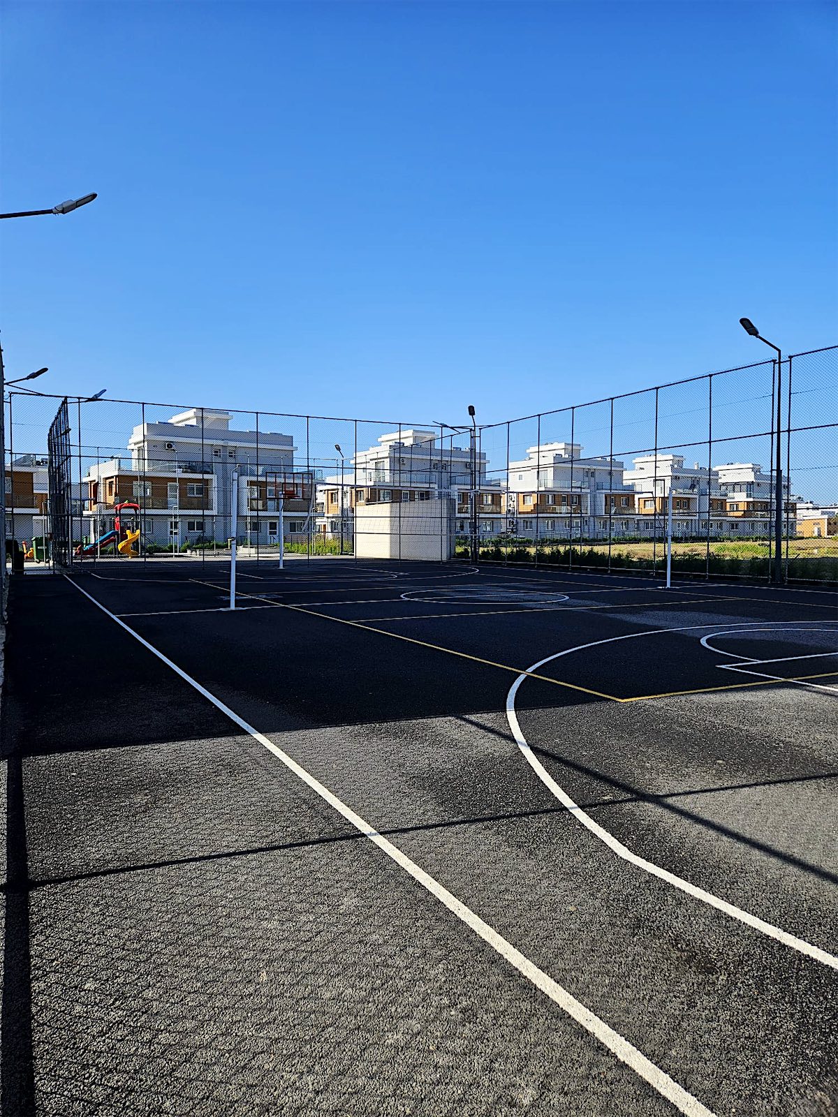 Fenced sports court inside the Royal residence